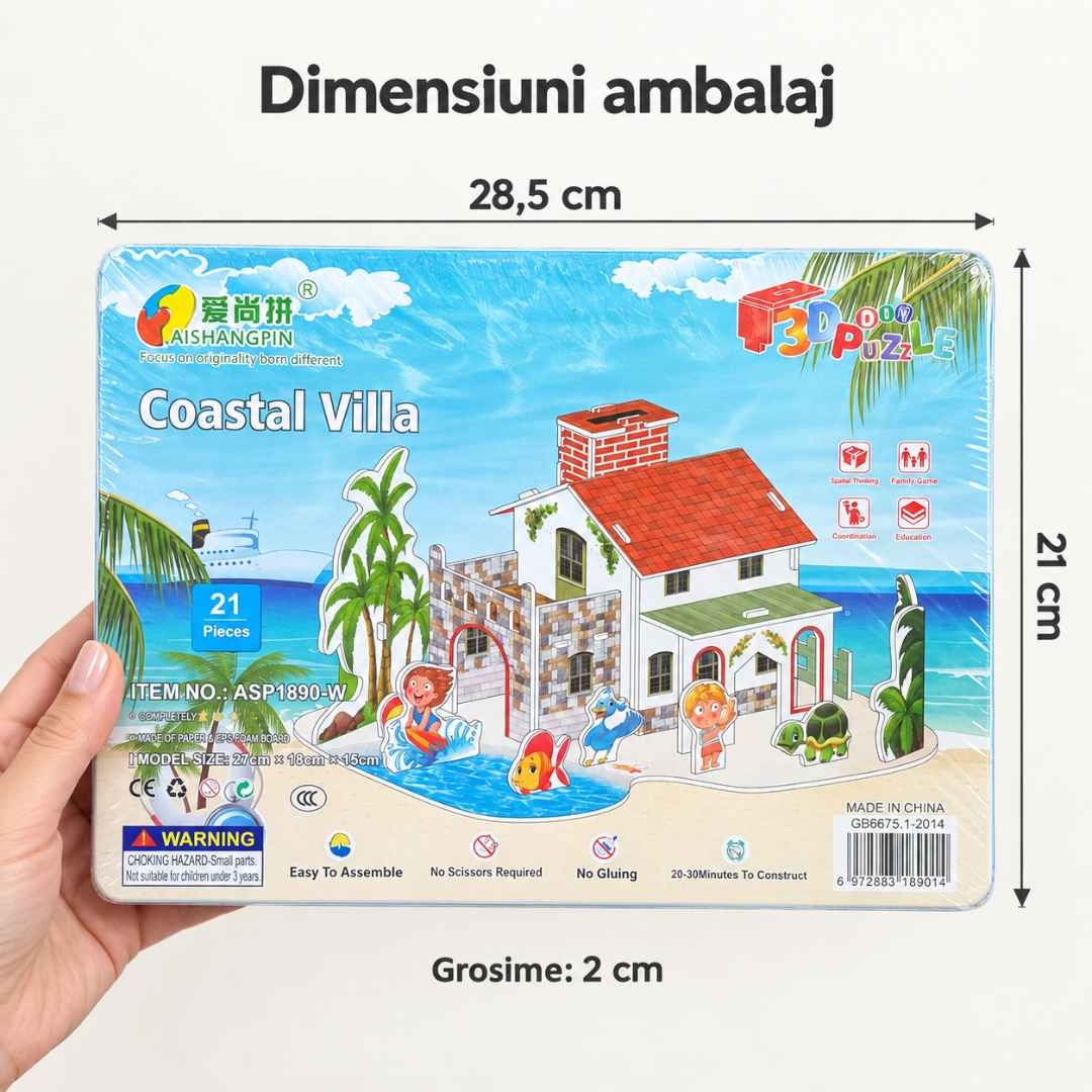 Ambalajul Coastal Villa ținut într-o mână, cu dimensiunile de 28,5 × 21 × 2 cm