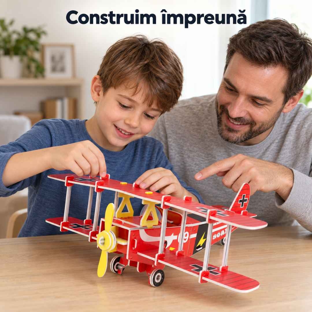 Tată și fiu construind împreună biplanul roșu, în timp ce copilul potrivește o piesă a aripii