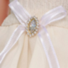 Păpușă Sennby Baby cu Rochie Alb-Crem și Accesoriu Elegant – 35 cm